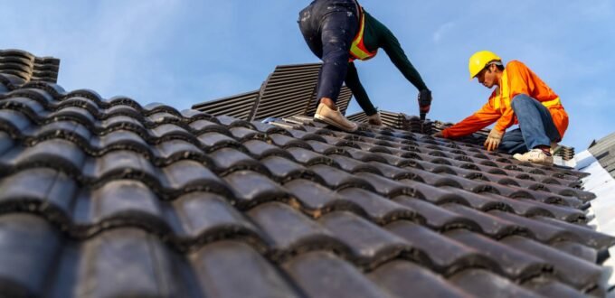 Roofers working on a tiled roof