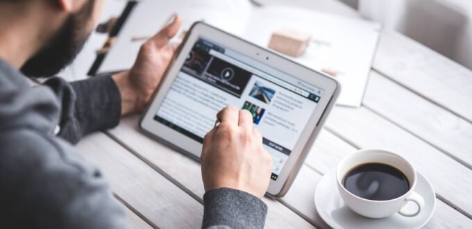 Tradesman checking his business Facebook page on a tablet